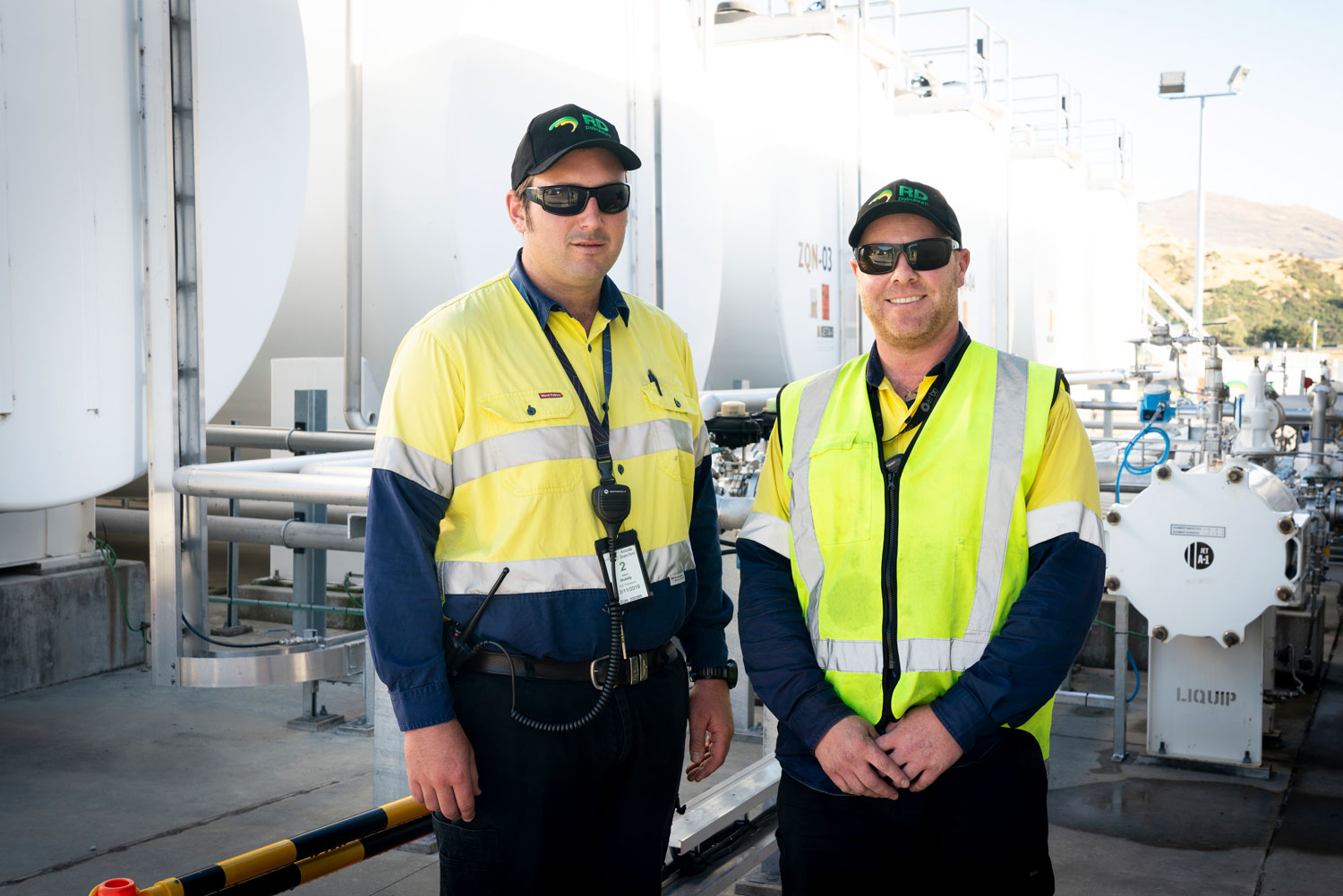 two-men-standing-in-front-of-aviation-machinery