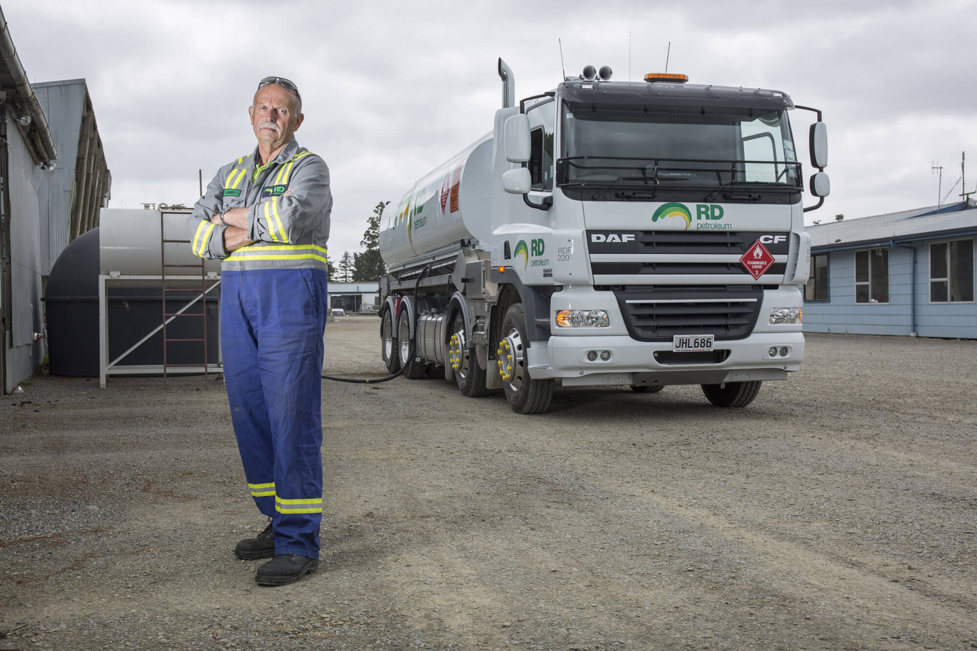 man-standing-in-front-of-rd-petroleum-truck